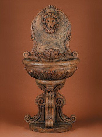 A classic lion head outdoor wall fountain.