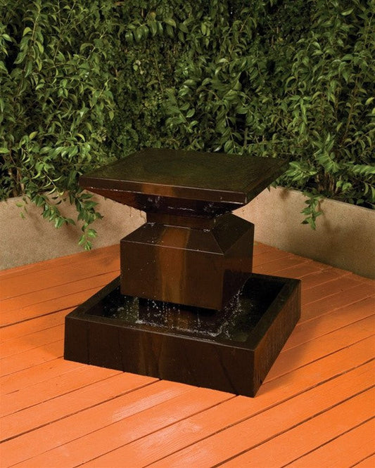 A stone garden water fountain with a tiered design.