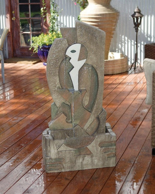A water fountain in a garden with art.