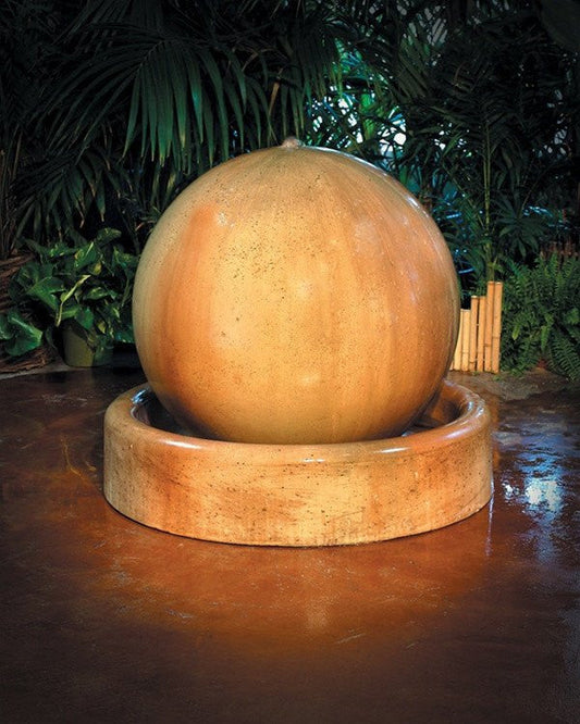 Garden water fountain with a ball and ring base.