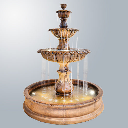 A three-tiered pond fountain with water flowing from the top basin to the bottom.
