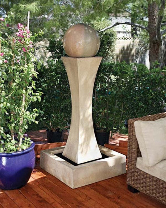 A water fountain with a ball in a garden