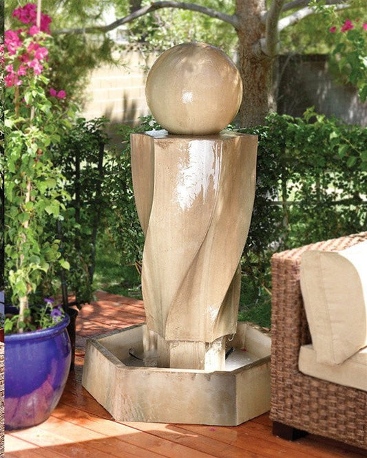 Outdoor water fountain with a vortex design and a ball feature.
