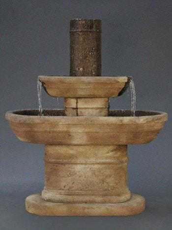 A tiered garden fountain in a desert landscape.